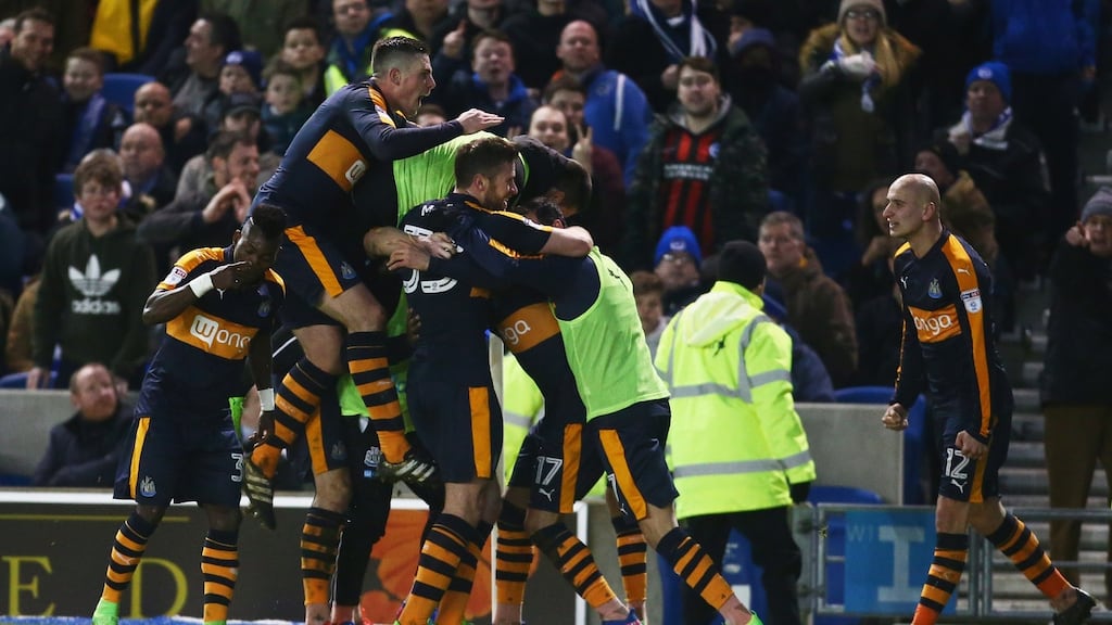 Ayoze Perez is mobbed by his Newcastle team-mates after scoring the winning goal in the Championship match against Brighton at the Amex Stadium. Photograph: Jordan Mansfield/Getty Images