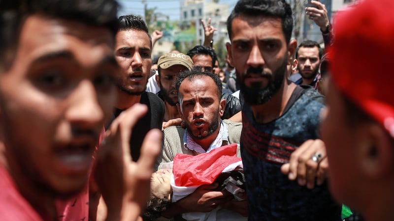 The father of Layla Ghandour carries her body during her funeral in Gaza City on Tuesday. Photograph: Hosam Salem/The New York Times