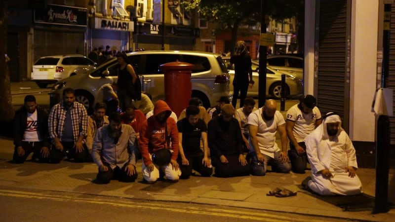 Muslims pray on a pavement in the Finsbury Park area of north London after a vehicle hit pedestrians in the early hours of Monday morning. Photograph: Daniel Leal-Olivas/AFP/Getty Images