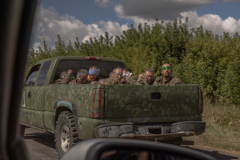 A Ukrainian military vehicle drives from the direction of the border with Russia carrying blindfolded men in Russian military uniforms, in the Sumy region, on Tuesday. Photograph: Roman Pilipey/AFP via Getty Images