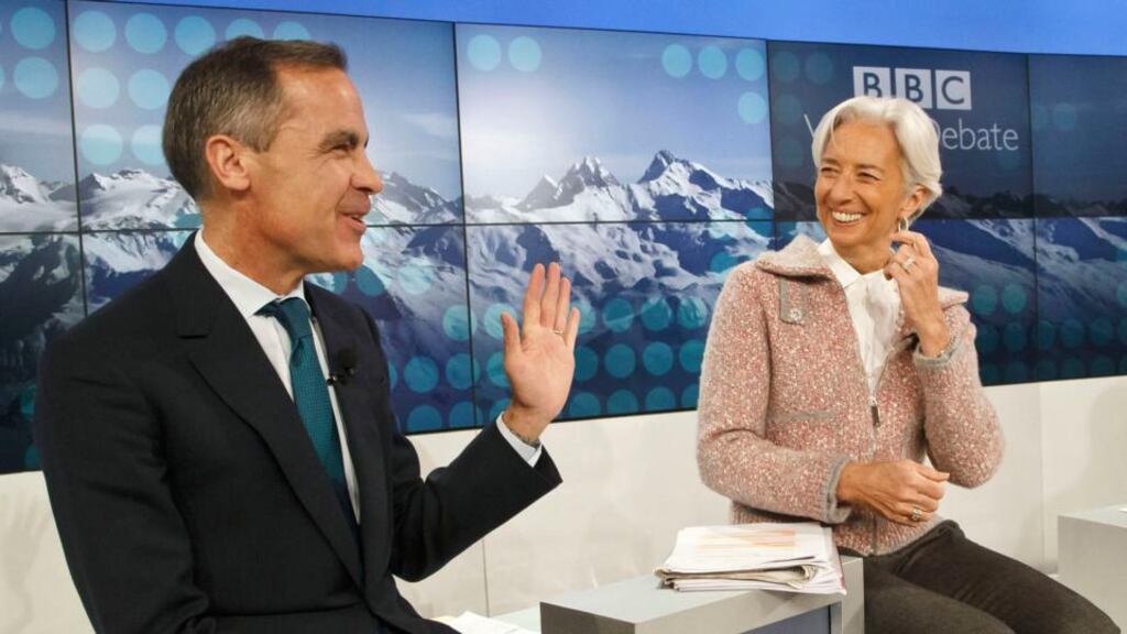 Governor of the Banks of England Mark Carney and managing director of the International Monetary Fund Christine Lagarde smile prior to a panel “A Richer World, but for Whom”at the World Economic Forum in Davos.