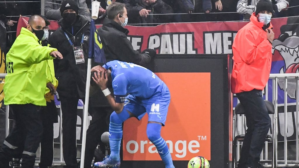 Marseille’s Dimitri Payet is hit by a water bottle during the match against Lyon. Photo: Philippe Desmazes/AFP via Getty Images