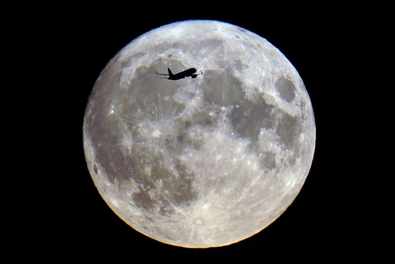 An aircraft passes the super blue moon in London. Photograph: Victoria Jones/PA Wire
