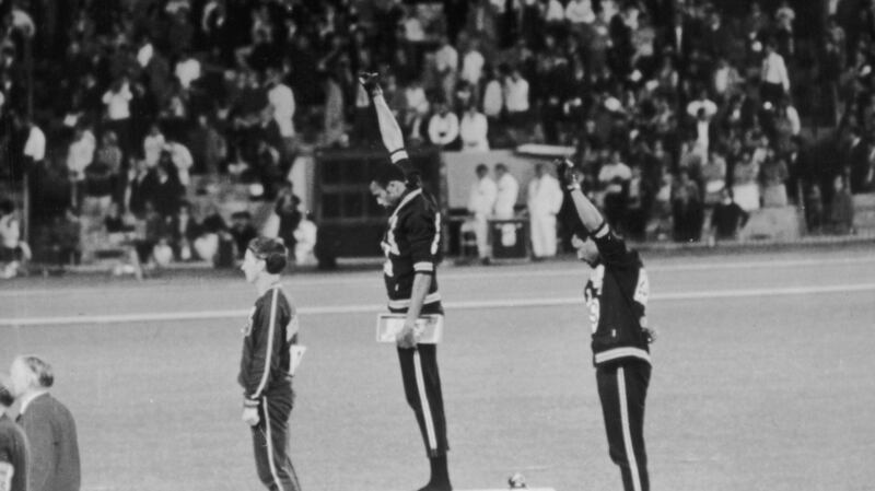 American sprinters Tommie Smith and John Carlos give the Black Power salute as they stand on the podium at the Mexico Olympics in 1968.