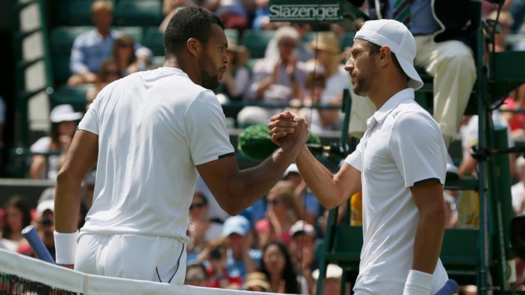 Jo-Wilfried Tsonga (France, left) shakes hands with Jurgen Melzer of Austria after defeating him in their men’s singles tennis match at Wimbledon. Photograph: Stefan Wermuth/Reuters