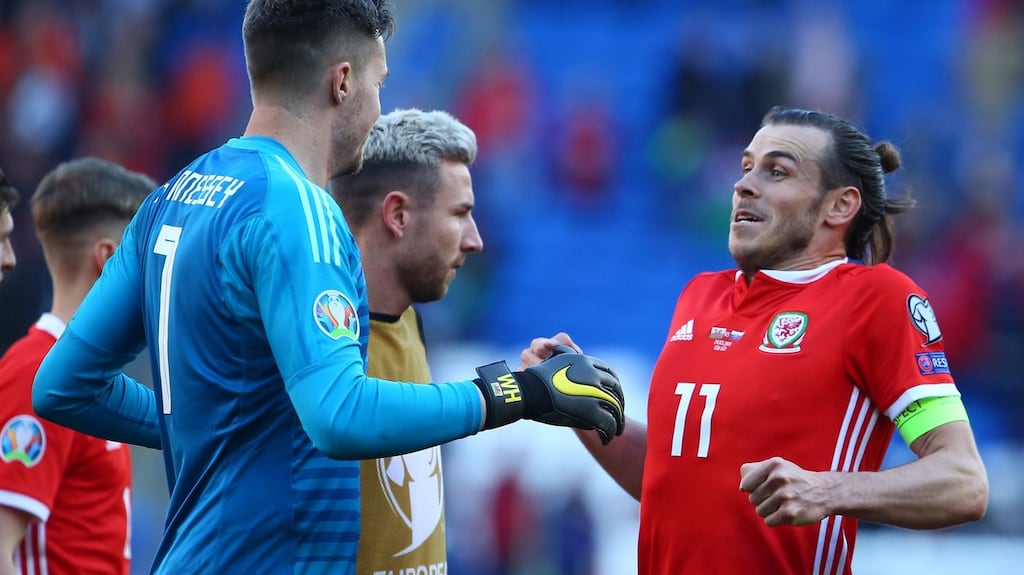 Wales goalkeeper Wayne Hennessey and Gareth Bale celebrate their win over Slovakia at Cardiff City Stadium. Photograph: Getty Images