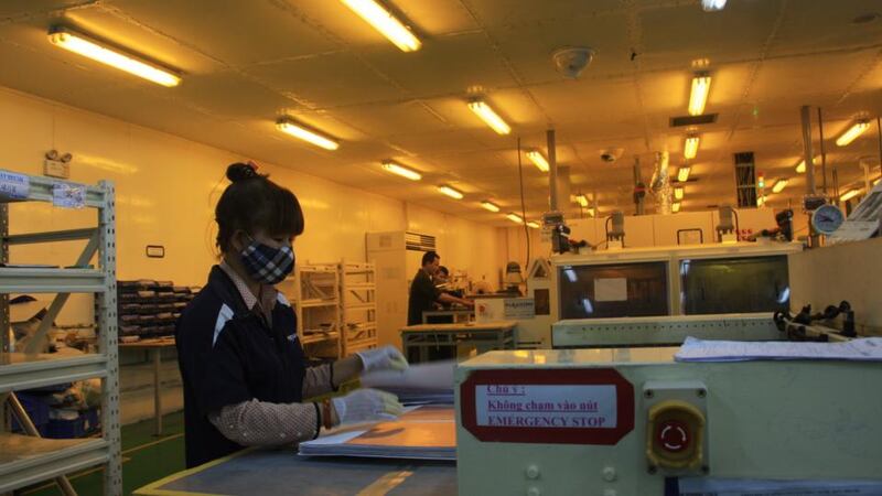 A worker prepares metal sheets at Flexcom’s factory in the Yen Phong industrial zone, Vietnam. Photograph: Catherine Healy