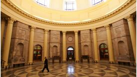 Bank official wants full pay during legal action