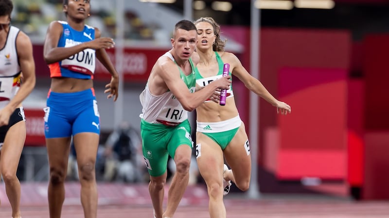 Ireland’s Sophie Becker passes the baton to Christopher O’Donnell during the mixed 4x400m relay. Photograph: Morgan Treacy/Inpho