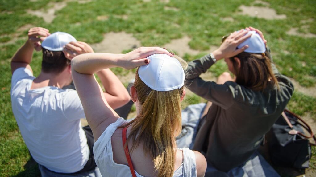Three young Germans stage a show of solidarity with Jewish people after a spate of anti-Semitic assaults in April. Photograph: Gregor Fischer/AFP/Getty Images