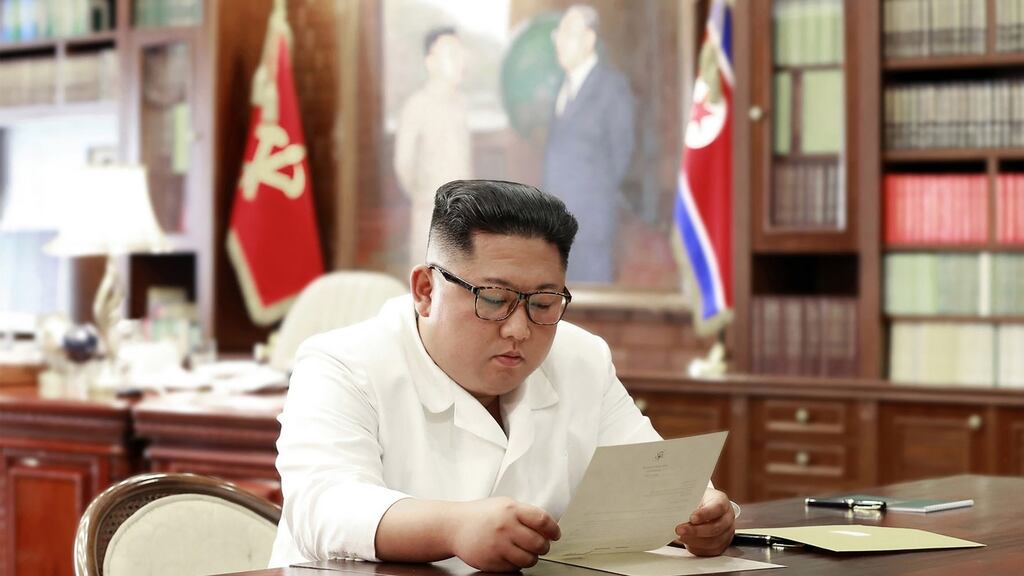 North Korean leader Kim Jong-un reading a letter from US president Donald Trump: Mr Kim says he will “seriously contemplate the interesting content”. Photograph: KCNA via KNS/AFP/Getty