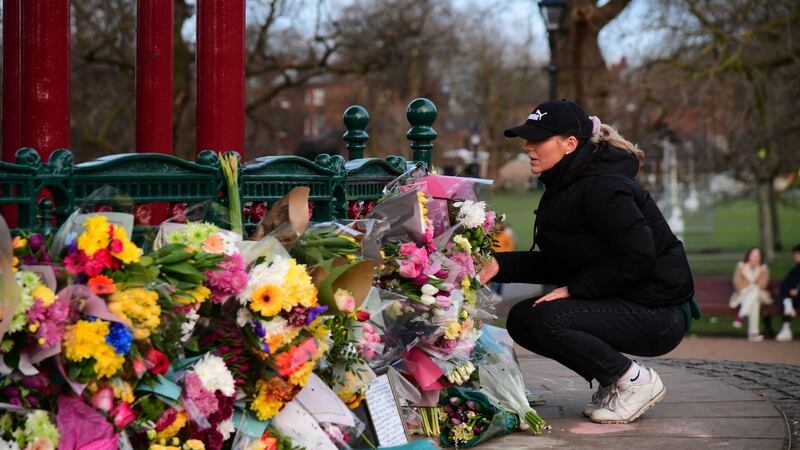 A woman leaves flowers at the bandstand on Clapham Common, after a body found hidden in woodland in Kent was been identified as that of 33-year-old Sarah Everard. Photograph: Ian West/PA Wire