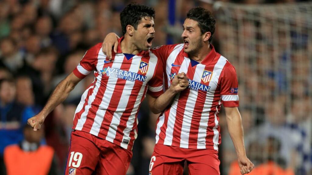 Atletico Madrid’s Diego Costa (left) celebrates with team-mate Koke after scoring his side’s second goal from the penalty spot at Stamford Bridge. Photograph: Nick Potts/PA Wire