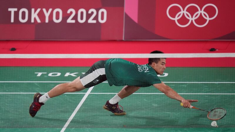 Ireland’s Nhat Nguyen reaches for a shot against Tzu-Wei Wang of Chinese Taipei during men’s singles group play stage. Photo: Dita Alangkara/AP Photo