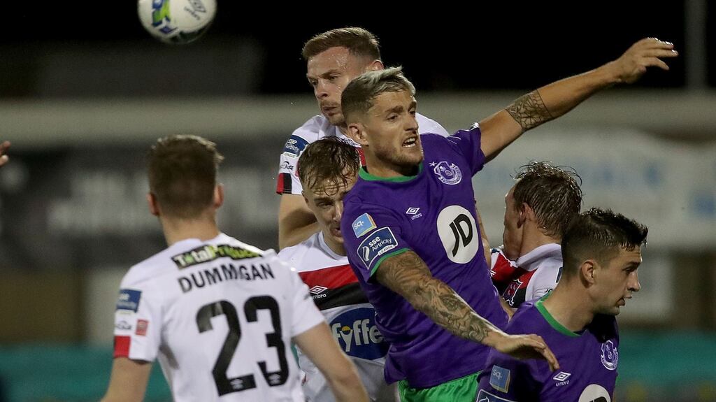 Dundalk’s Andy Boyle and Lee Grace of Shamrock Rovers contest a ball in the air during the Premier Division clash between the two teams in September. Photo: Bryan Keane/Inpho