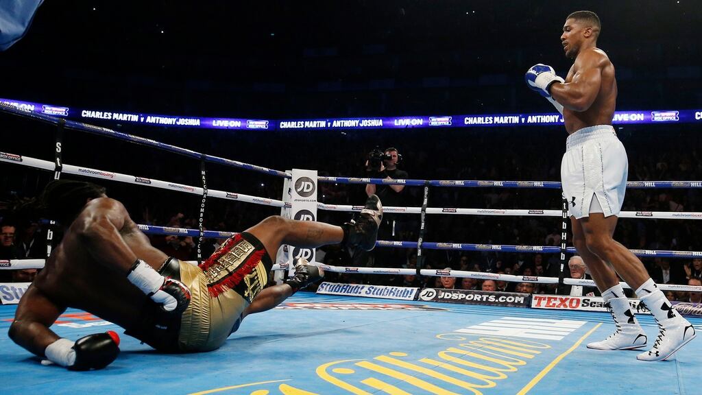 Charles Martin is knocked down by Anthony Joshua in their IBF World Heavyweight Title fight at the O2 in London. Photo: Reuters