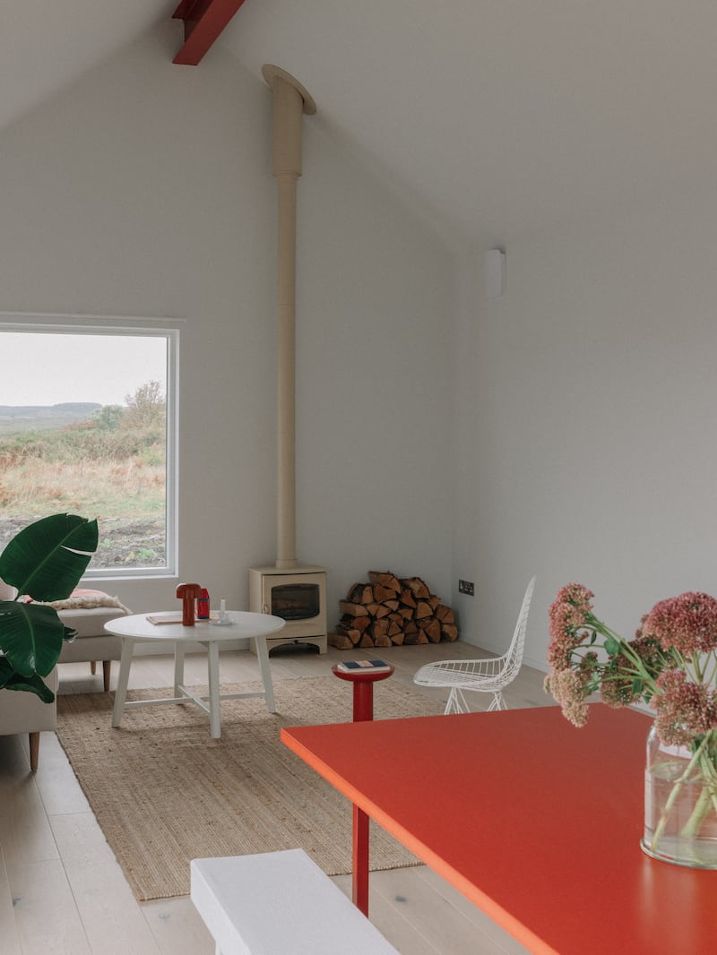 Summerage: Living area with wood-burning stove. Photograph: Shantanu Starick