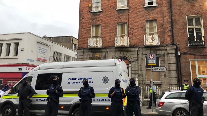 Gardaí from the public order unit stand outside the property on 34 North Frederick Street. Six people were arrested following confrontations, during which some officers used their batons. Photograph: Jack Power