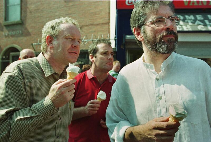 The Sinn Fein president Mr Gerry Adams and former Education Minister Mr Martin McGuinness enjoy an ice cream while watching yesterday's march in Belfast to commemorate the 19th anniversary of the Hunger Strikes in 2000. Photograph: Frank Miller / The Irish Times