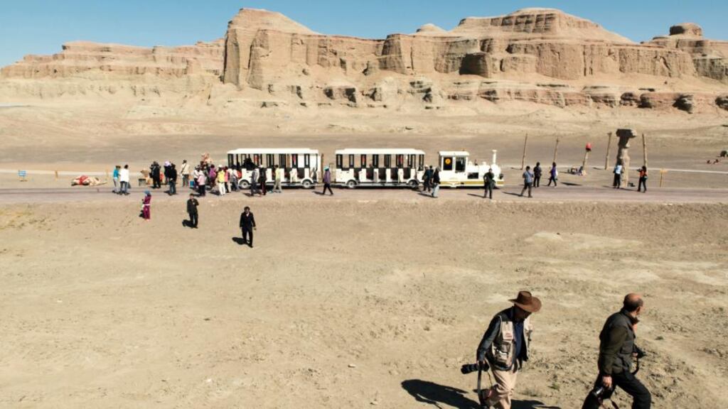Tourists visit a park near Karamay, in China’s Xinjiang province. Xinjiang has long been a destination for Chinese travellers, but mounting reports of ethnic riots and terror attacks have severely hurt tourism here. Photograph: Gilles Sabrie/The New York Times
