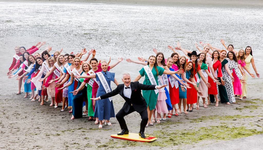 The tide is out and the skies overcast on Tuesday morning when Dáithí Ó Sé, surrounded by 29 women in dresses, sashes and heels, mounts a bodyboard on Sandymount Strand. Photograph: Andres Poveda
