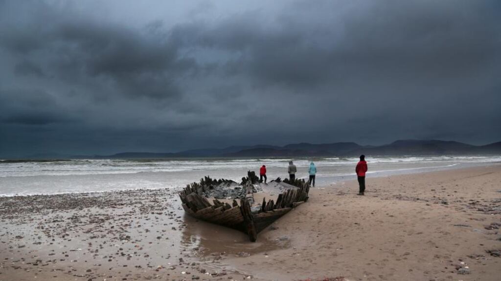 Walkers out braving the elements as gale force winds drift into the Atlantic on Rossbeigh Stand, County Kerry. Photograph: Valerie O’Sullivan
