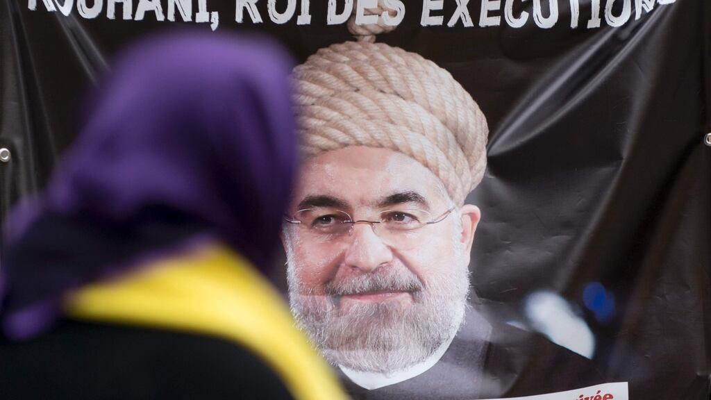A banner used by demonstrators in Vienna, Austria last week against Iranian President Hassan Rohani over Iran’s use of the death penalty. Iran put at least 977 people to death in 2015, compared to at least 743 the year before, according to Amnesty. Photograph: Joe Klamar/AFP/Getty Images