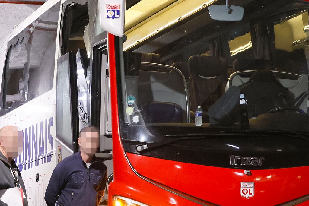 Lyon's team bus with one window completely broken and another damaged after it was stoned as it entered the Stade Velodrome ahead of the game against Marseille. Photograph: Christophe Simon/AFP via Getty Images