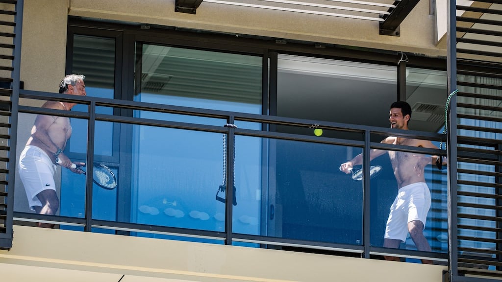 Novak Djokovic playing tennis on his balcony at the M Suites in Adelaide. Photograph: Morgan Sette/AFP via Getty Images