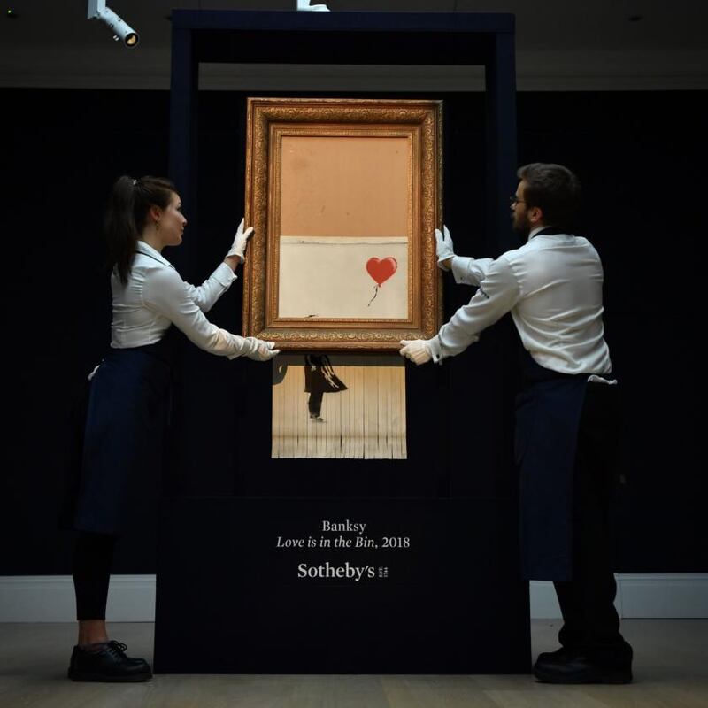 At a Sotheby’s sale in 2018, just as the hammer fell on Girl with Balloon by Banksy, for which the buyer paid in excess of £1 million (€1.17 million), the piece went through a shredder in the frame. Photograph: Ben Stansall/AFP/Getty
