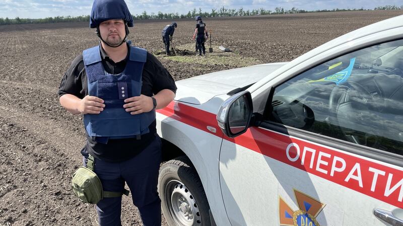 Artur Silchenko, a sapper for Ukraine’s state emergency service, in a field in Kharkiv where a Russian Uragan rocket landed.