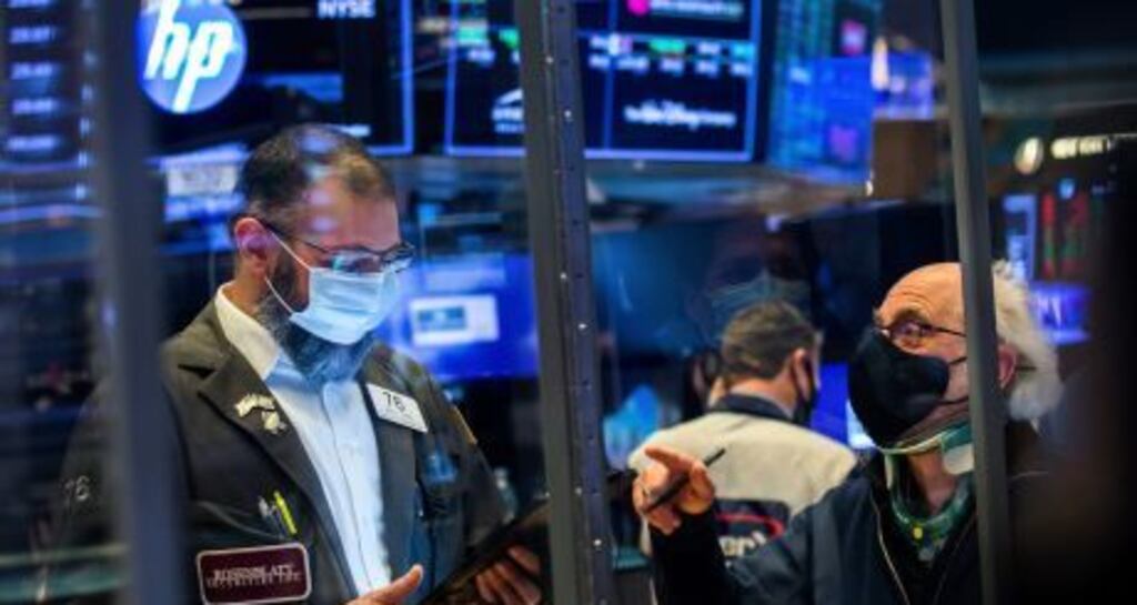 Traders work on the floor of the New York Stock Exchange on Wall St.