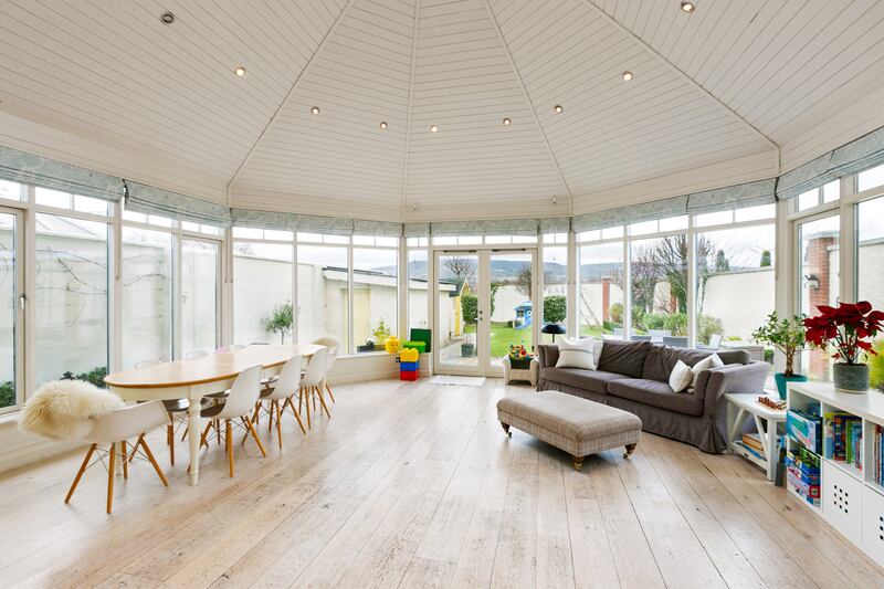 To the right of the hall are two interconnecting reception rooms stretching from the front and to the back