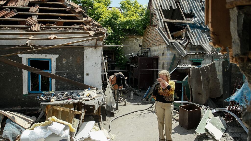 A woman whose home was destroyed by shelling in the pro-Russian controlled Staromykhaylivka village near Donetsk last week. Photograph: Alexander Ermochenko/EPA