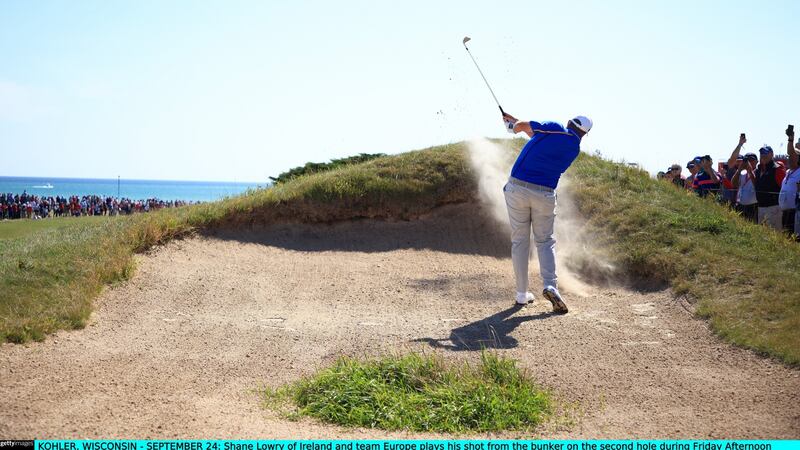 Shane Lowry his shot from the bunker on the second hole during Friday afternoon fourball matches. Photograph: Mike Ehrmann/Getty Images