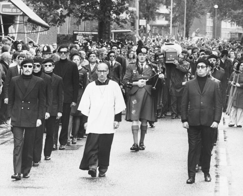 The funeral procession of Irish armed robber, Michael Gaughan, who died in Parkhurst Prison after a 65 day hunger strike. His coffin is preceded by a piper and flanked by members of the Irish Republican army as it is carried through the streets of Kilburn. (Photo by © Hulton-Deutsch Collection/CORBIS/Corbis via Getty Images)
