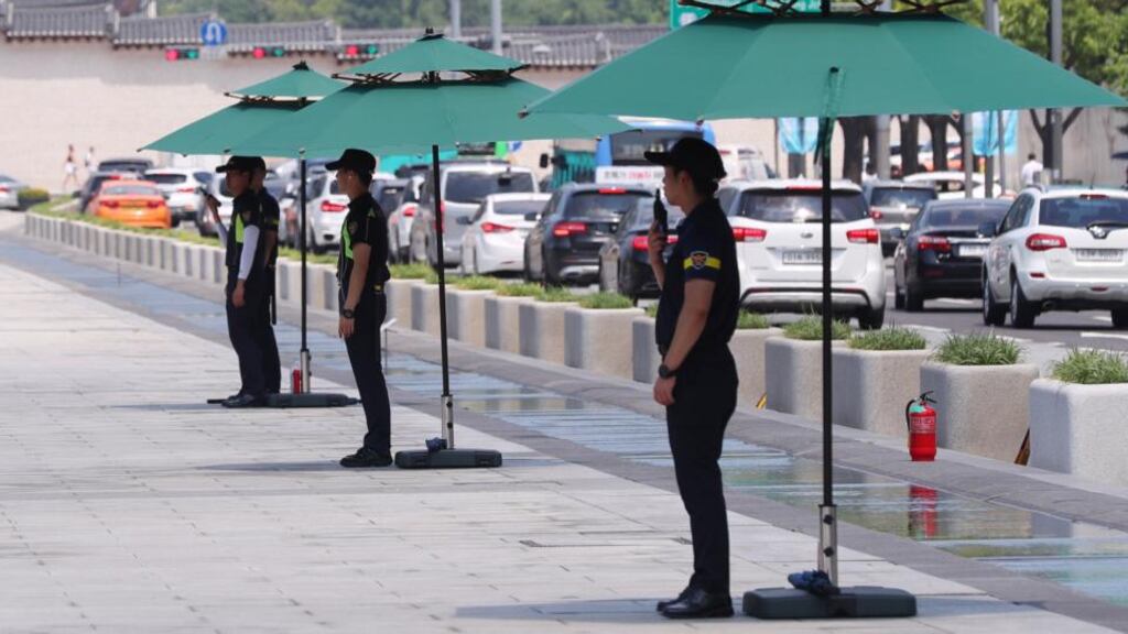 Police officers stand guard under the shade of canopies at Gwanghwamun Square in Seoul, South Korea on August 1st, 2018. Photograph: EPA/Yonhap South Korea Out