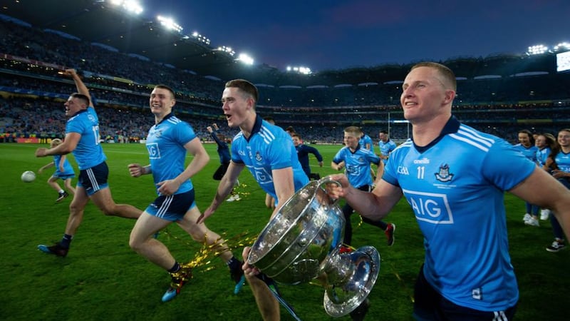Dublin’s Brian Fenton and Ciaran Kilkenny celebrate with teammates after the final whistle. Photograph: Tom Honan/The Irish Times