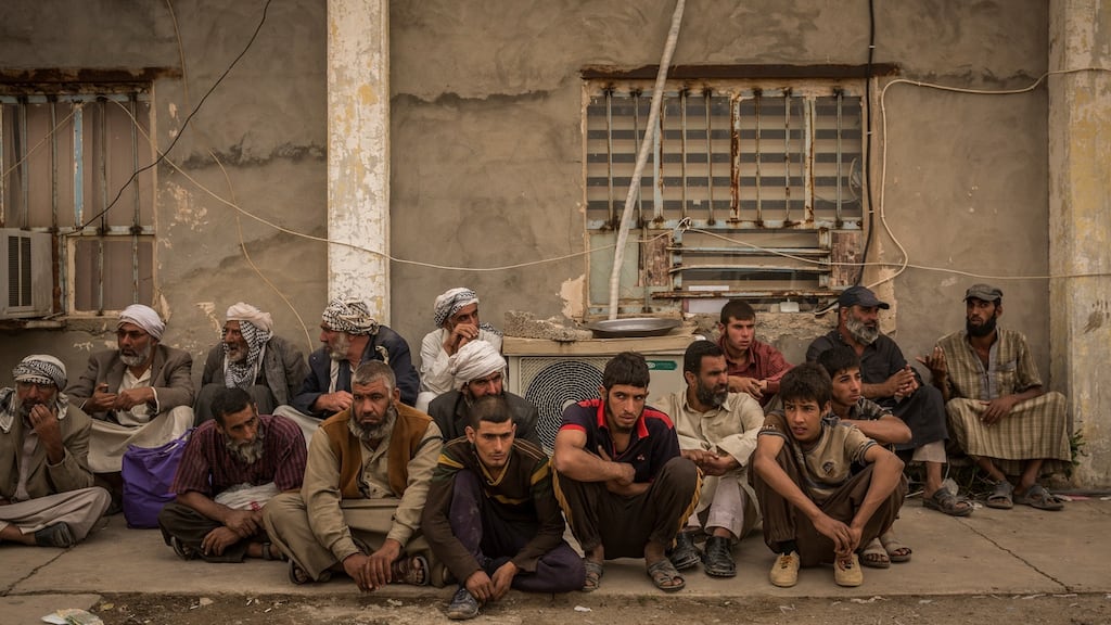 Men suspected of being Islamic State fighters wait to be questioned at a security screening centre near Kirkuk, Iraq on October 4th. Photograph: Ivor Prickett/The New York Times