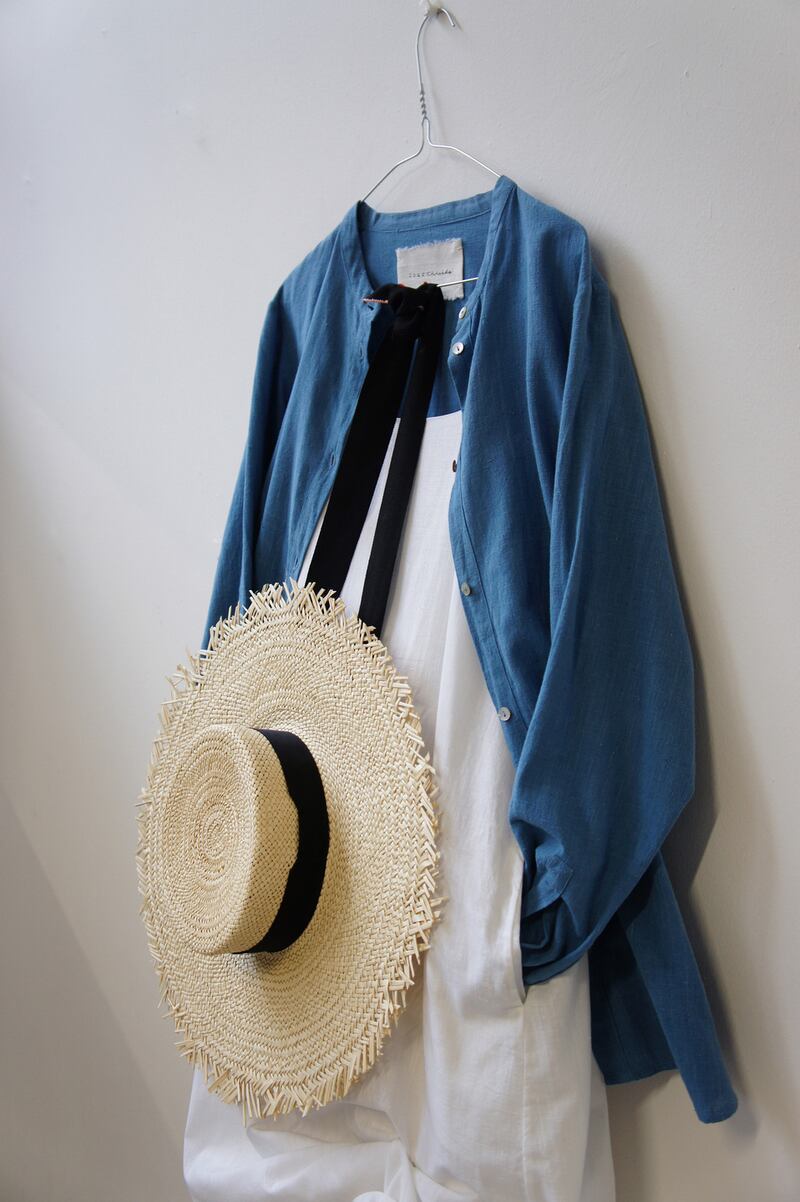 Indigo button down shirt €290, white slip dress €310, Clementine natural straw boater with extra large brim €189.