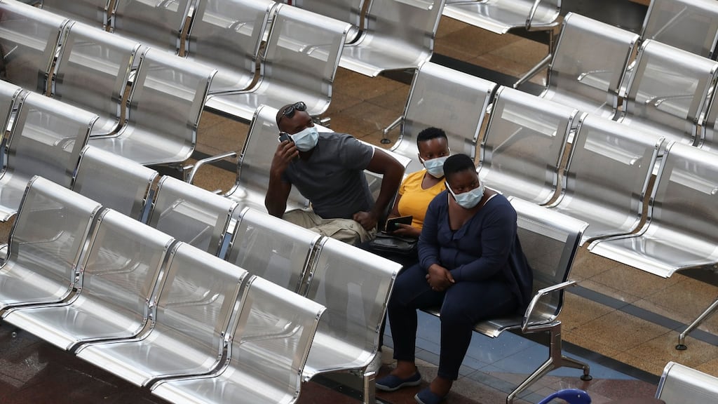 People wait at OR Tambo International Airport in Johannesburg on Friday. Photograph: Siphiwe Sibeko/Reuters