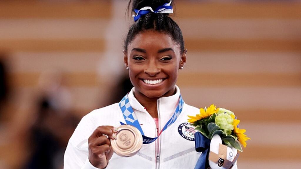Simone Biles celebrates with the bronze medal during the women’s balance beam final medal ceremony at the Tokyo 2020 Olympic Games. Photograph: Jamie Squire/Getty Images