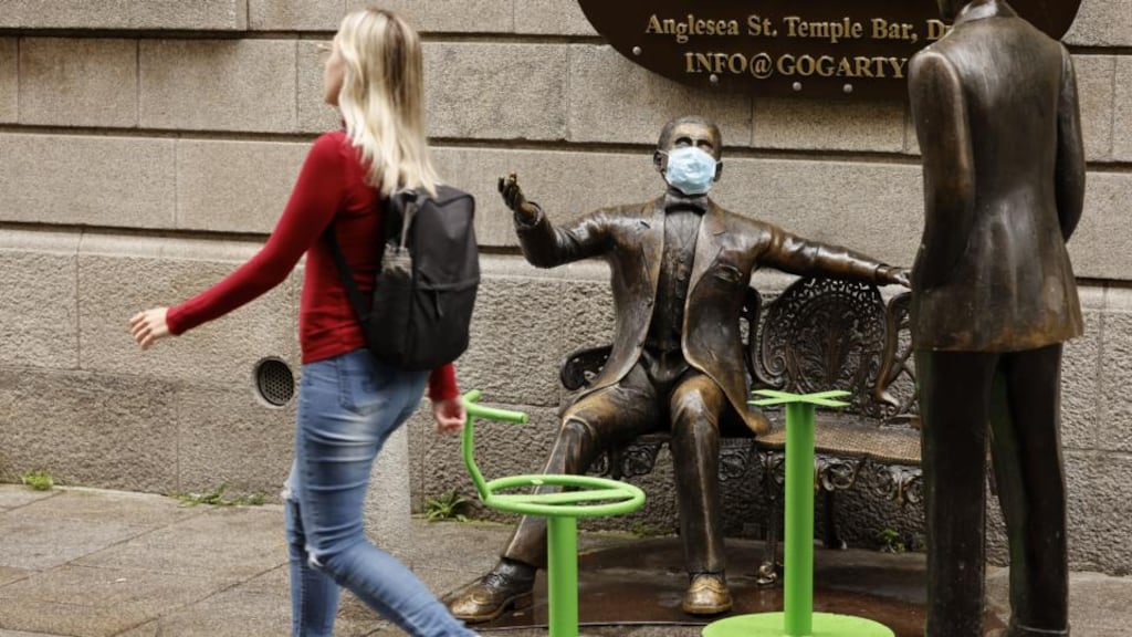 Mask-wearing statues in Temple Bar: UK data shows protection against infection provided by the Pfizer vaccine dropping from 88 per cent one month after vaccination to 74 per cent at five to six months.  Photograph: Alan Betson