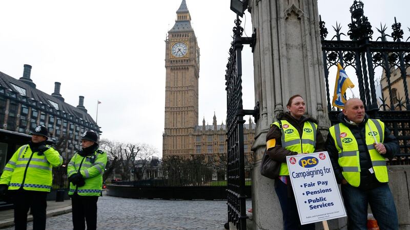 Striking members of the Public and Commercial Services Union (PCS) picket the Houses of Parliament in London, where British finance minister George Osborne faces the task of delivering another austerity budget. Photograph: Reuters/Andrew Winning.