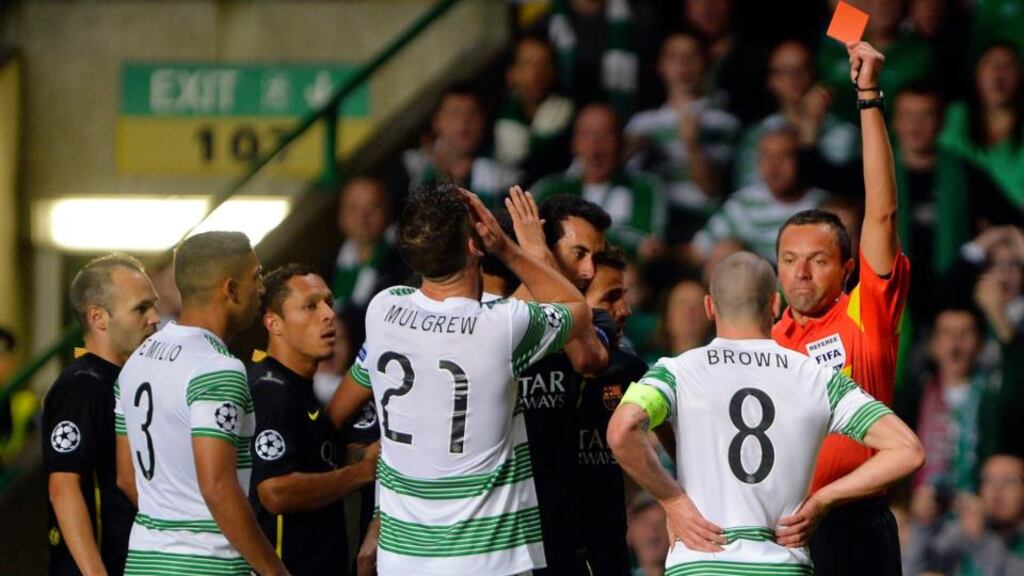Celtic’s Scott Brown (second right) is shown a red card by referee Stephane Lannoy during their Champions League soccer match against Barcelona at Celtic Park in Glasgow. Photograph: Russell Cheyne/Reuters