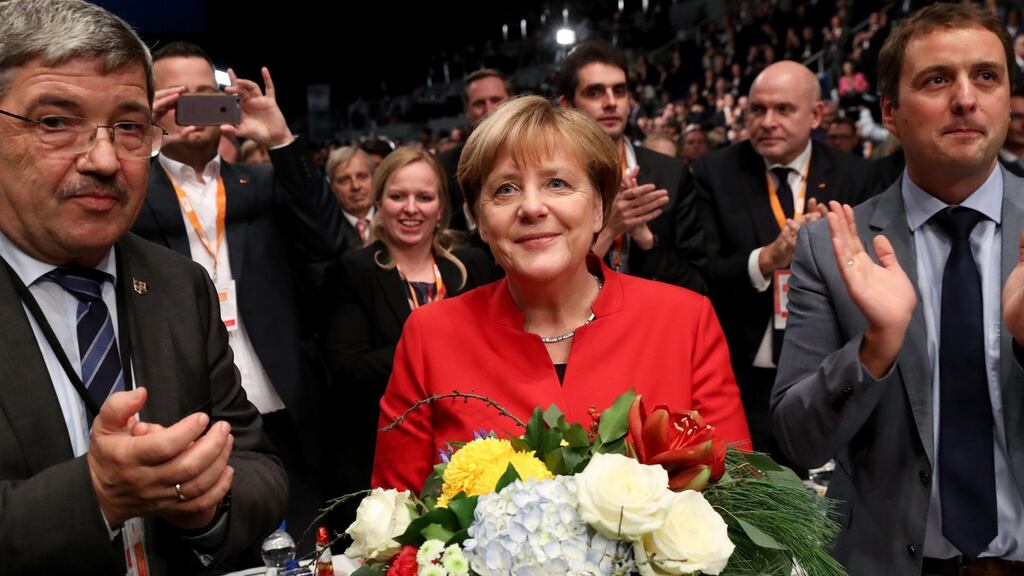 German chancellor Angela Merkel is celebrated by party members after she was re-elected chairwoman of the CDU at the party’s convention in Essen, Germany, on Tuesday. Photograph: EPA/Michael Kappeler