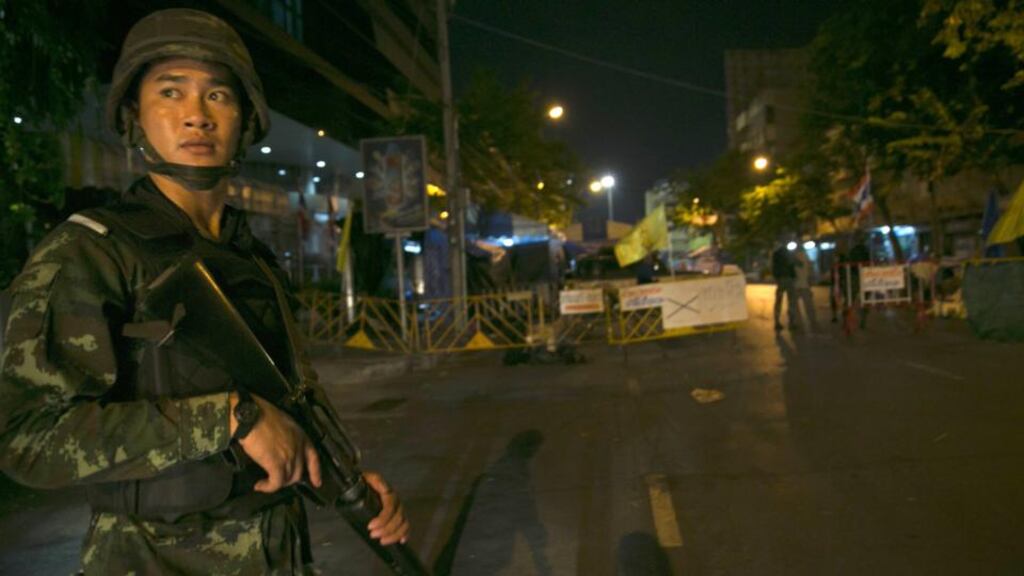 A Thai soldier stands guard after a curfew started at 10pm in Bangkok, Thailand. Photograph: Paula Bronstein/Getty Images
