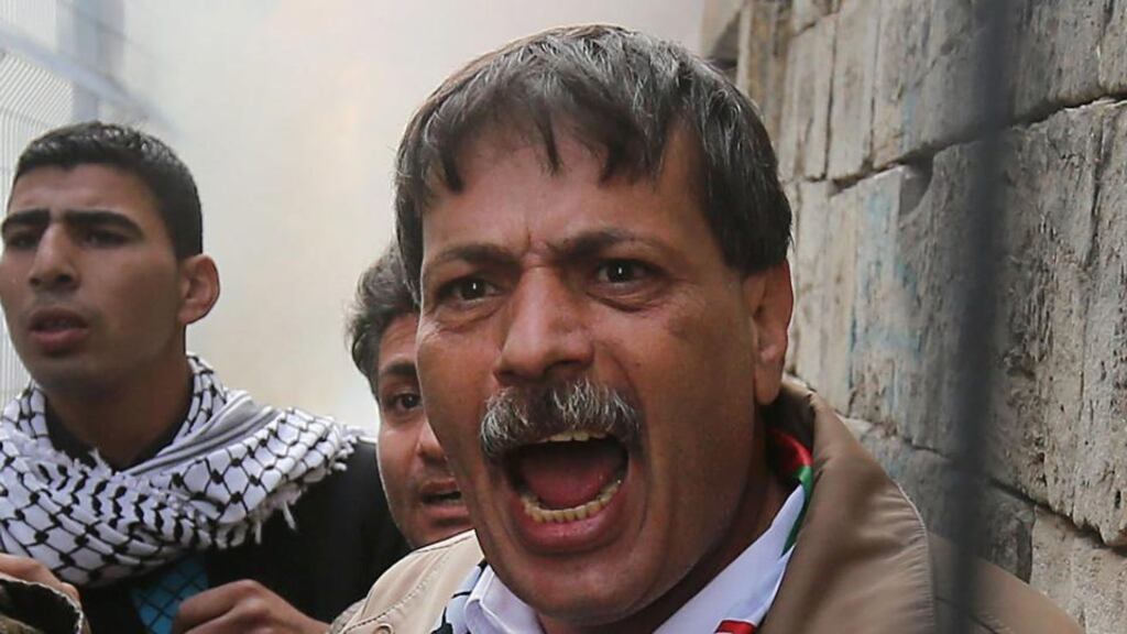 A file picture from November 2014 showing Palestinian Authority minister Ziad Abu Ein shouting towards Israeli soldiers from behind a fence on the Palestinian side of the divided West Bank city of Hebron. According to media reports he was reportedly killed during a confrontation with Israeli soldiers. Photograph: EPA