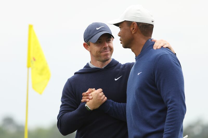 Rory McIlroy shakes hands with Tiger Woods on the 18th green after they completed a practice round before the 2023 Masters Tournament at Augusta National Golf Club. Photograph: Christian Petersen/Getty Images