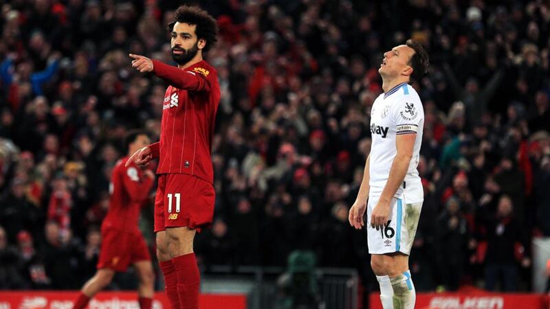 Mohamed Salah celebrates after scoring Liverpool’s equaliser while Mark Noble looks dejected. Photograph: Peter Byrne/PA